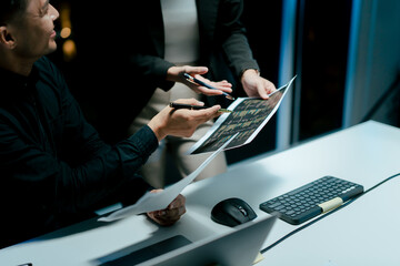 Teamwork colleagues working in the evening to develop or plan discussions, suggestions or ideas with business men and women working in the evening.