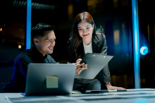 Teamwork colleagues working in the evening to develop or plan discussions, suggestions or ideas with business men and women working in the evening.