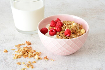 Healthy Breakfast Granola with Yogurt, Raspberries, oat flakes and a Glass of Milk