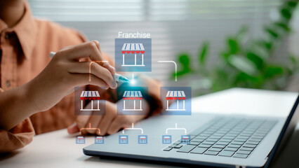 Franchise business model development shown by entrepreneur managing multi-level store network on laptop, concept of scalable investment, expansion strategy, and digital retail system.