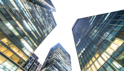 Nighttime Low-Angle Perspective of Contemporary Glass Towers Against a White Background
