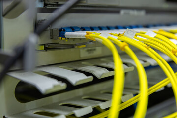 Network cables connected to switches. Fiber Optical cables connected to an optic ports and Network...