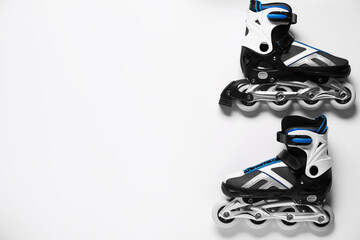 Pair of roller skates on white background, top view