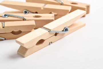 Wooden clothes pegs isolated on white background