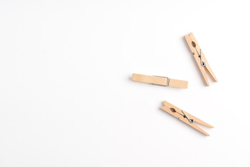Wooden clothes pin isolated on white background. Top view, flat lay