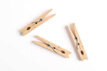 Wooden clothes pin isolated on white background. Top view, flat lay