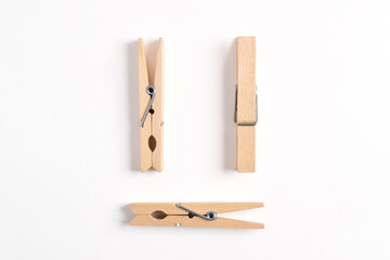 Wooden clothes pin isolated on white background. Top view, flat lay
