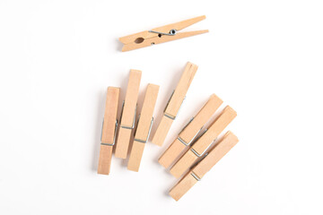Wooden clothes pin isolated on white background. Top view, flat lay