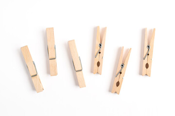 Wooden clothes pin isolated on white background. Top view, flat lay