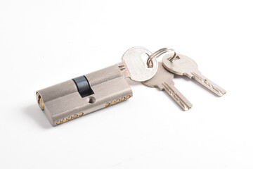The cylinder of the lock with a pair of keys and isolated on the white background.