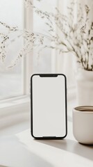 Minimalist smartphone displayed with coffee cup on sunlit windowsill
