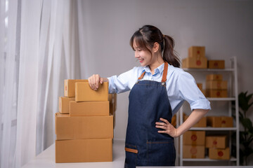 Online seller arranging delivery boxes on table in warehouse