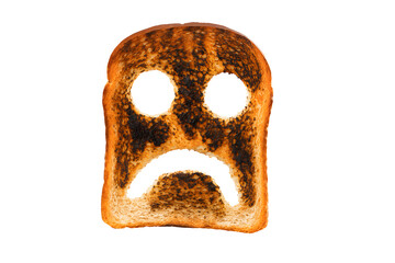 Burnt toast with sad face expression, overcooked bread slice isolated on white, emotional breakfast concept, unhappy food art, kitchen mishap, moody meal symbolism, humorous culinary creativity image
