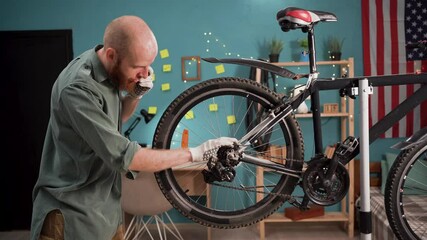 American young bearded man repairing bicycle at home calling technical support hotline consulting with bike repair professional