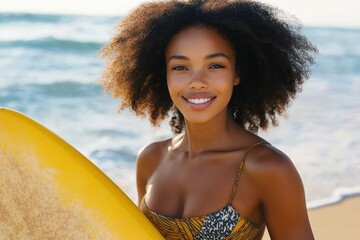 young woman with curly hair smiling while holding yellow surfboard at the beach on a sunny day