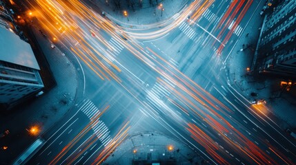 An aerial view of a busy city intersection, dynamically capturing the rush of traffic with streaks of light, showcasing the vibrant energy and pace of urban life.