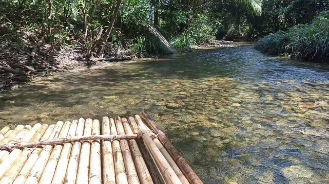 traveling sailing bamboo raft on river in tropical forest jungle