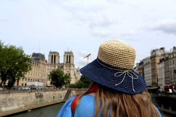 Femme au chapeau devant Notre-Dame à Paris