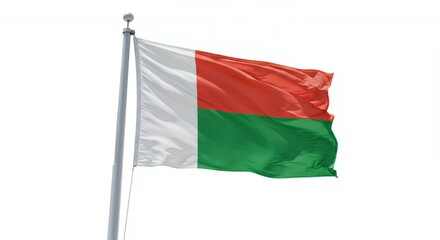 Madagascar's vibrant flag billows proudly against a clear sky, a symbol of national pride.