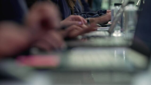 Group of People Typing on Keyboards – Office or Tech Workspace. A team of individuals working side by side, typing on computer keyboards. Office collaboration, coding, data entry.