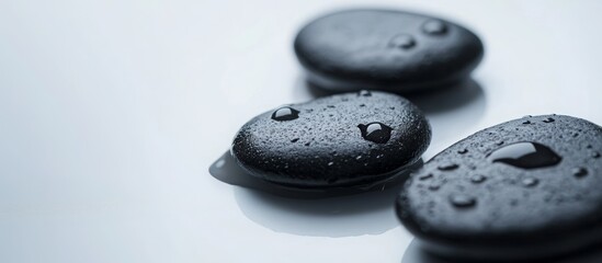 Glistening water droplets cascading over polished black stones, conveying serenity and calm, symbolizing wellness, spa ambiance, meditative tranquility