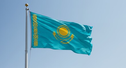 Kazakhstan's vibrant flag billows proudly against a clear blue sky.