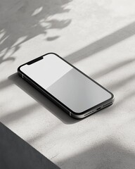 Minimalist smartphone on sunlit concrete surface with shadow play