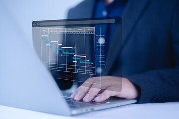 Businessman marking the schedule. Businessman using laptop create a calendar program, rganize and...