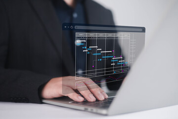 Businessman marking the schedule. Businessman using laptop create a calendar program, rganize and...
