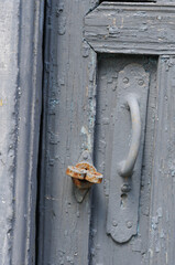 Old wooden door with a lock and a rusty bolt, close-up