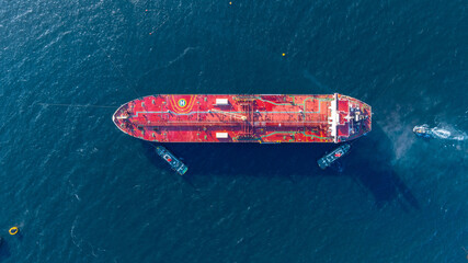 Aerial view oil ship tanker vessel loading and unloading in oil terminal station refinery, Global...