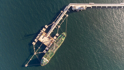 Aerial view oil ship tanker vessel loading and unloading in oil terminal station refinery, Global...