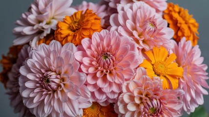 Vibrant bouquet of pink dahlias and orange marigolds in bloom