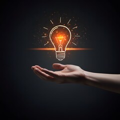 Hand holding a glowing light bulb symbolizing a bright idea or innovation