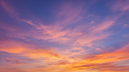 Fototapeta premium Vibrant Sunset Sky Fiery Orange Hues Melting Into Soft Lavender and Blue Clouds
