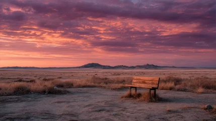 Fototapeten Lonely bench in a serene desert landscape beneath a stunning sunset sky © standret