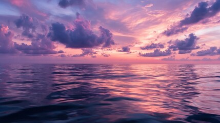 Obraz premium Serene sunset with vibrant colors reflecting on the calm ocean surface