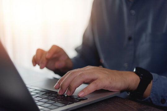 Hands typing on laptop keyboard, online collaboration, and technology, digital communication, and efficient workflow in a modern office environment.