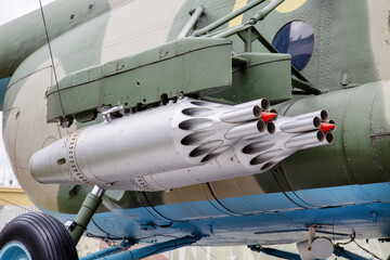 An anti-tank missile system mounted on a helicopter body. on a sunny day. Military equipment and...