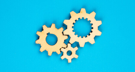 Wooden cogwheels on blue background 
