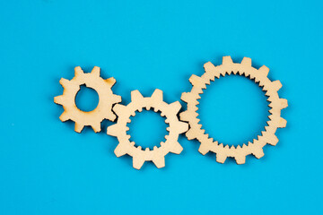 Wooden cogwheels on blue background 