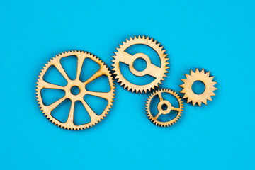 Wooden cogwheels on blue background 