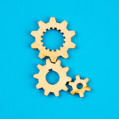 Wooden cogwheels on blue background 