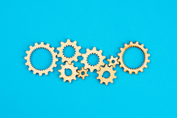 Wooden cogwheels on blue background 