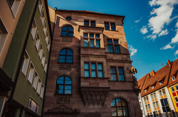 Naklejka premium Old architectural building in Nuremberg city against blue bright sky. Cityscape