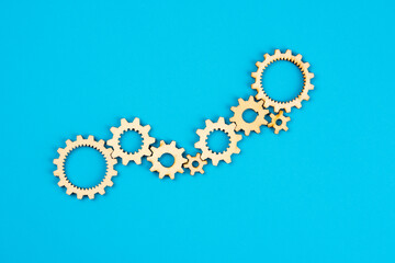 Wooden cogwheels on blue background 