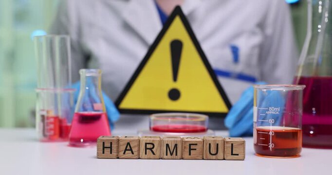 A lab with hazardous materials and a caution sign stressing the importance of safety in chemical handling
