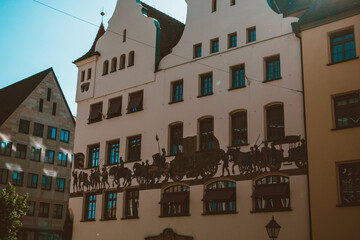 Old architectural building in Nuremberg city against blue bright sky. Cityscape