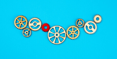 Wooden cogwheels on blue background