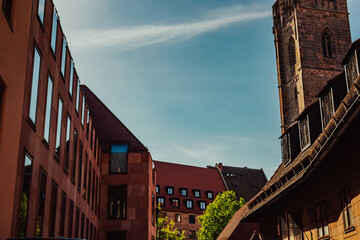 Old architectural building in Nuremberg city against blue bright sky. Cityscape